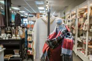 red, white, and green patterned scarf on a mannequin in accessories, inc