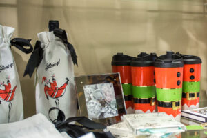 santa wine bottle holder and travel mugs decorated like elf costumes