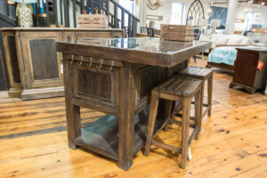 dark brown bar table with two barstools underneath