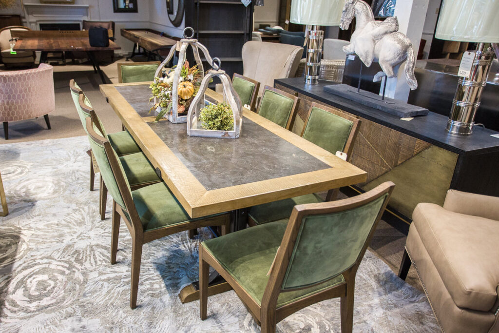 rectangular dining table with 8 green chairs