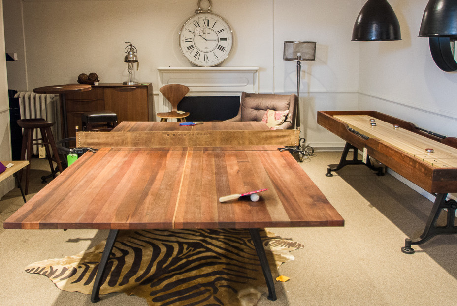 large wooden game table on an animal print rug