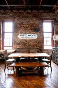 Handcrafted natural live edge dining table with chairs in greenfront furniture showroom