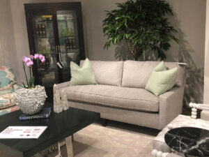 Light gray stanford couch with mint colored pillows