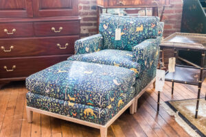 Chair and footstool upholstered with a forest and animal pattern