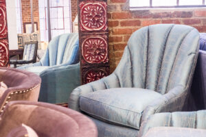 silver upholstered chair in green front furniture showroom