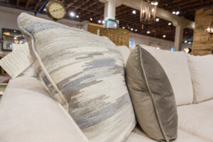 two patterned beige pillows on a beige couch