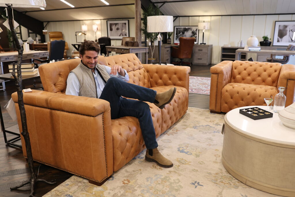 Man sitting in light brown leather reclining sofa