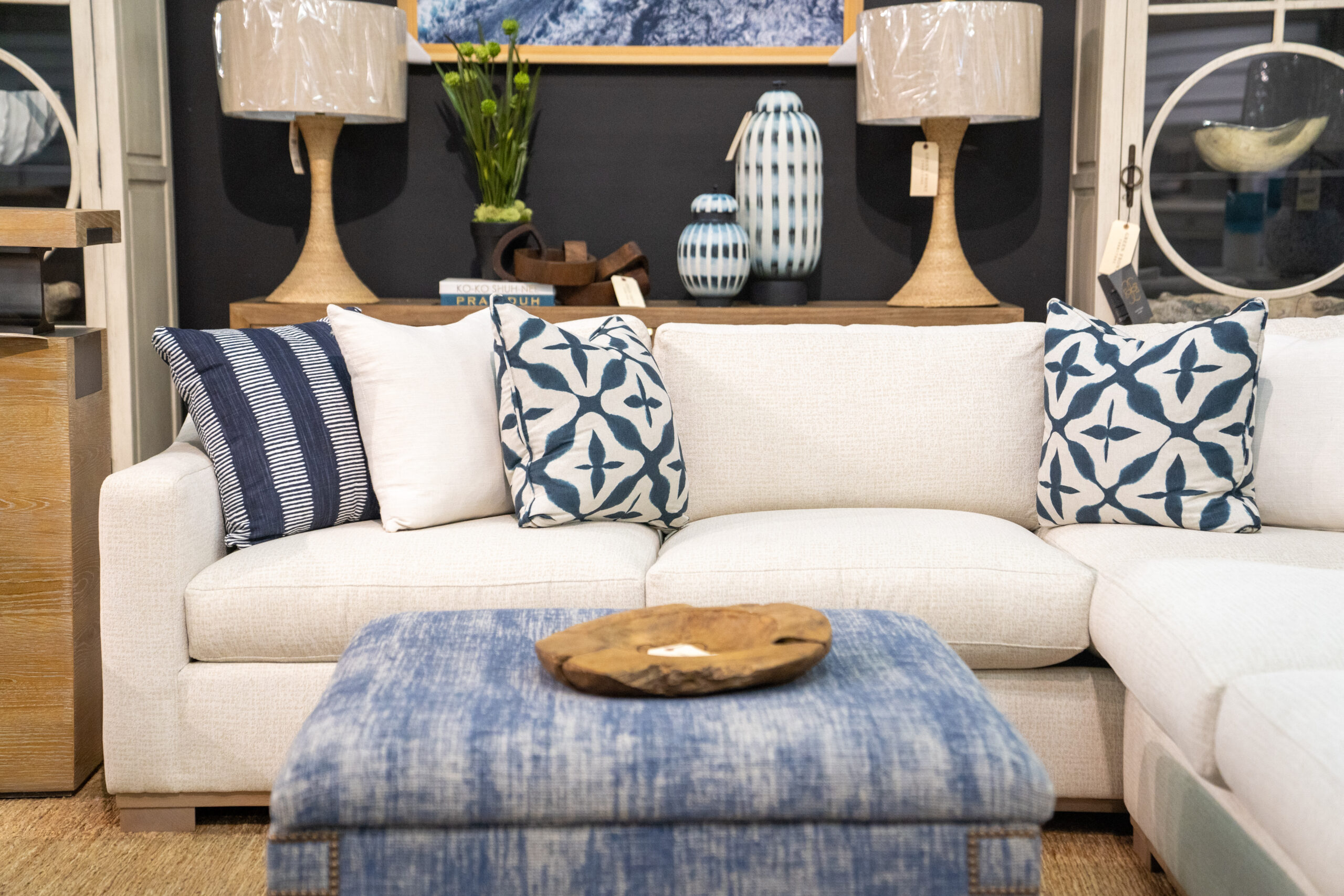 white sectional with navy and white decorative pillows